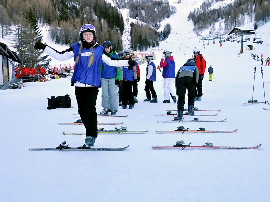 Skifahrer breitet auf der Piste die Arme aus.